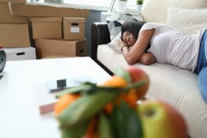 Woman fell asleep from fatigue while folding boxes